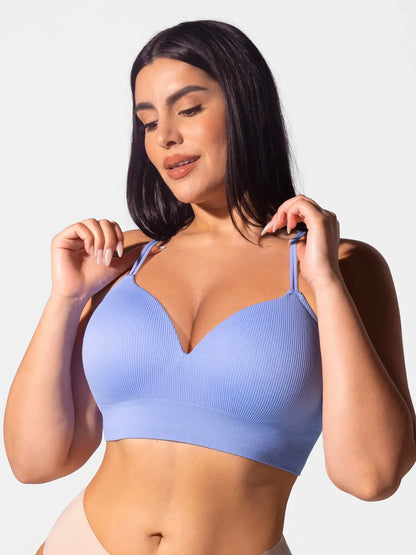 Model lifting double straps on Feelingirl seamless ribbed wireless bra – front view showing convertible strap design