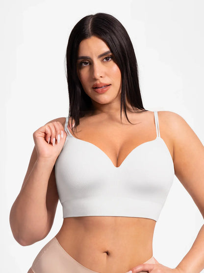 Model lifting double straps on Feelingirl seamless ribbed wireless bra – front view showing convertible strap design