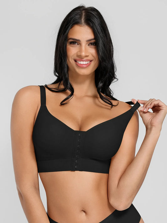 A woman modeling a black wireless bra with a center-button closure, shown against a light gray studio background.