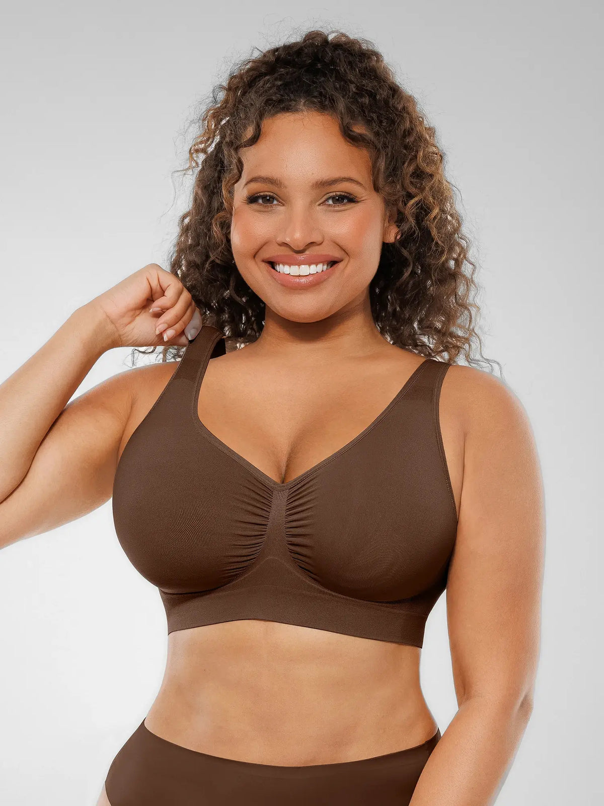Front profile of a brown seamless wireless bra showing wide shoulder straps designed to distribute weight evenly without digging