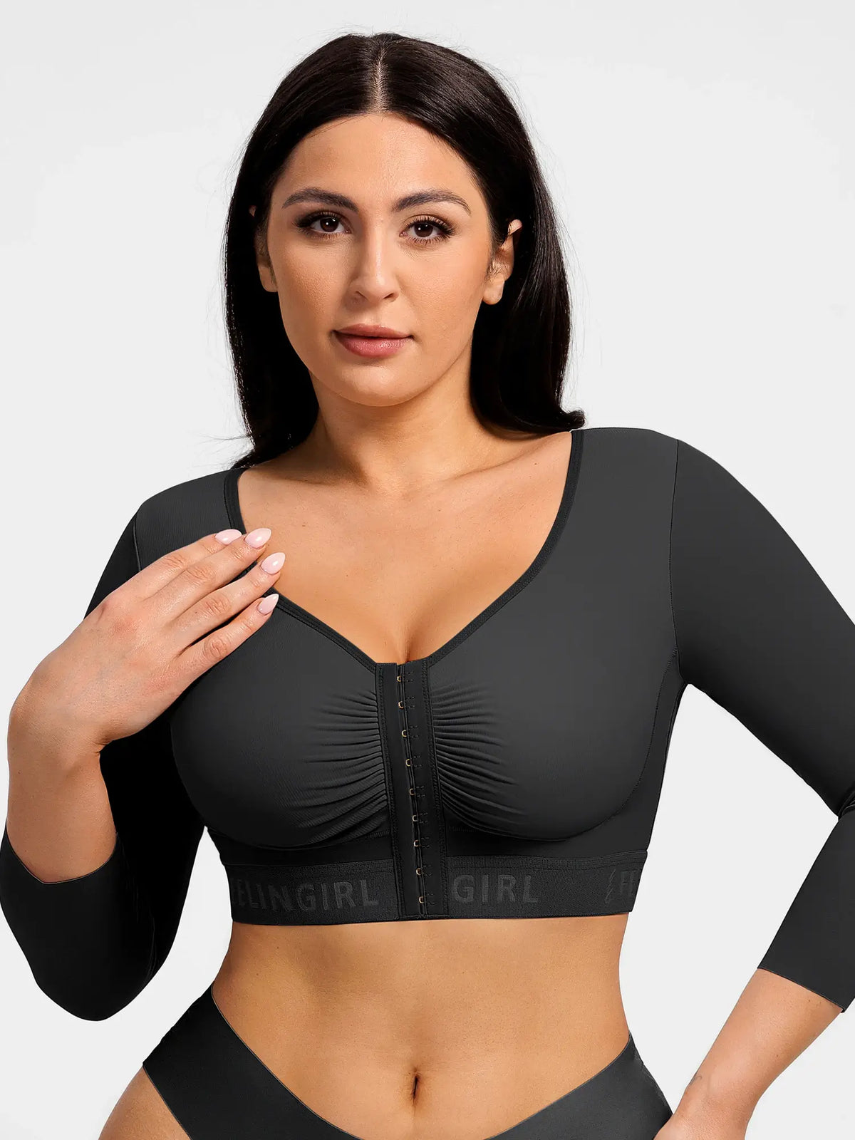 Black post-surgery arm shaping top with 3/4 sleeves and front hook closure on a model for post-op recovery.