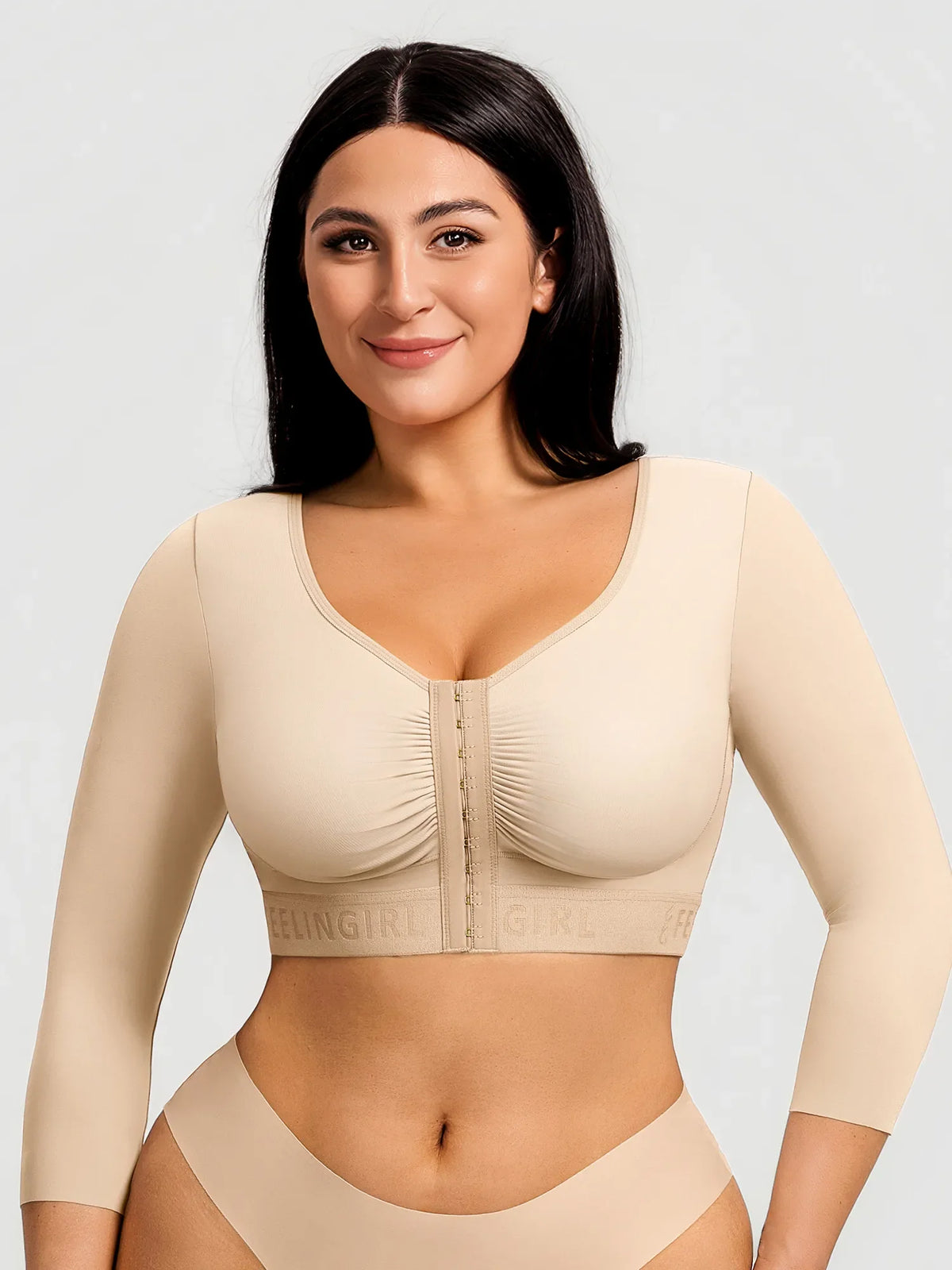 Khaki post-surgery arm shaping top with 3/4 sleeves and front hook closure on a model for post-op recovery.